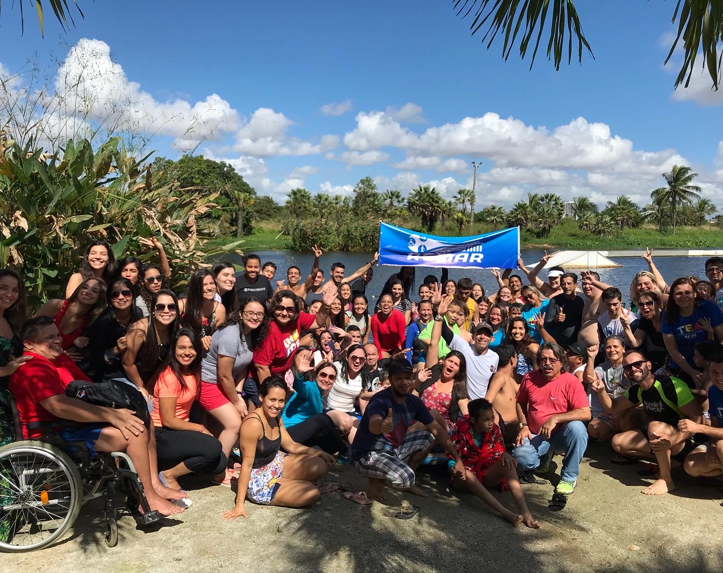Participante com deficiência em atividade aquática acompanhado por voluntário